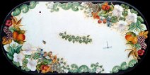 Art: TROFF-00100 Tavolo in pietra lavica ovale con decoro , fiori di cappero, fichi d'india, uva, melograni, arance, spighe di grano, calle, insetti e bordo intagliato a rilievo